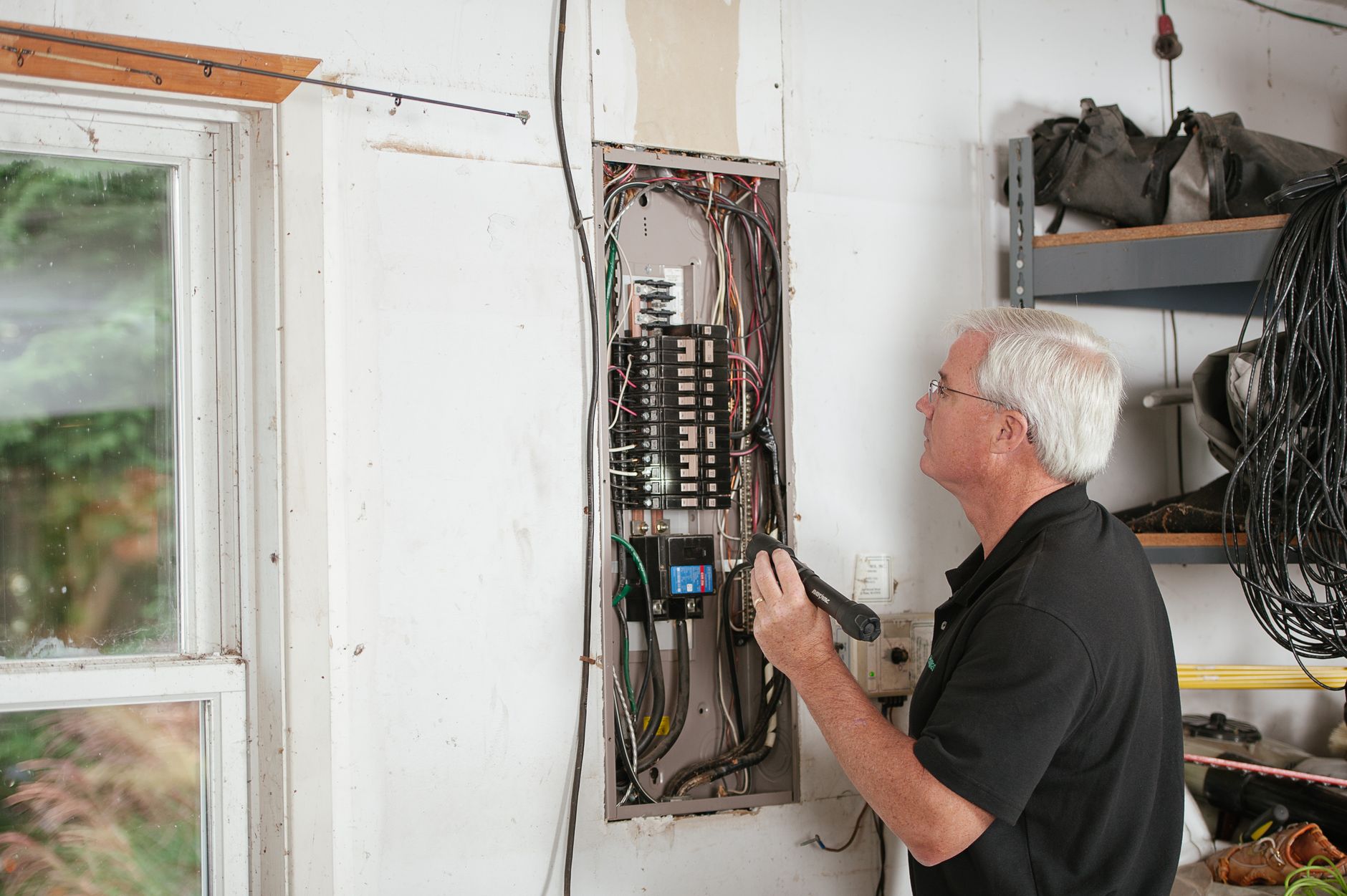 Licensed electrical inspector testing distribution board panel
